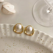 Elegant gold pearl stud earrings, perfect for jewelry cleaning, jewelry storage, jewelry websites, or featuring as a timeless piece by top jewelry designers.