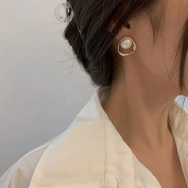 Elegant gold pearl stud earrings, perfect for jewelry cleaning, jewelry storage, jewelry websites, or featuring as a timeless piece by top jewelry designers.