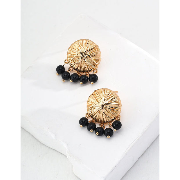 Gold-plated round earrings with black bead dangles, perfect for vintage jewelry lovers, jewelry storage in cases, and jewelry websites featuring elegant designs.