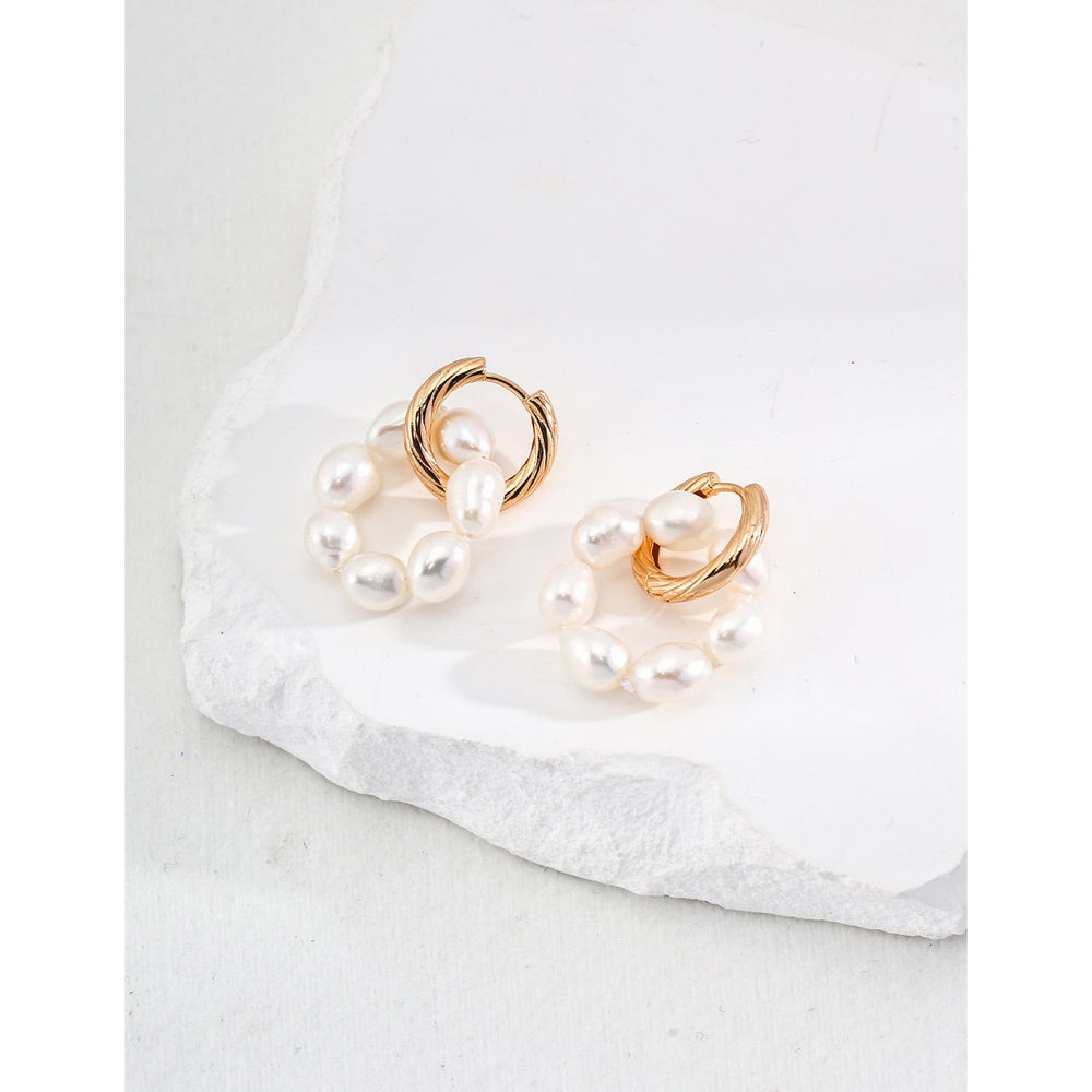 Elegant gold and pearl hoop earrings for timeless style, ideal for jewelry storage in a jewelry case. Perfect for jewelry websites, earrings piercing, and jewelry brands.