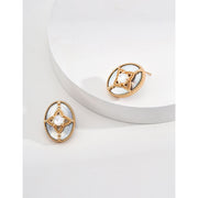 Vintage-inspired gold and pearl oval earrings ideal for jewelry storage, designed by expert jewelry designers, perfect for earrings piercing and mature women hairstyles.