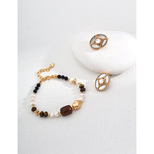 Vintage-inspired gold and pearl oval earrings ideal for jewelry storage, designed by expert jewelry designers, perfect for earrings piercing and mature women hairstyles.