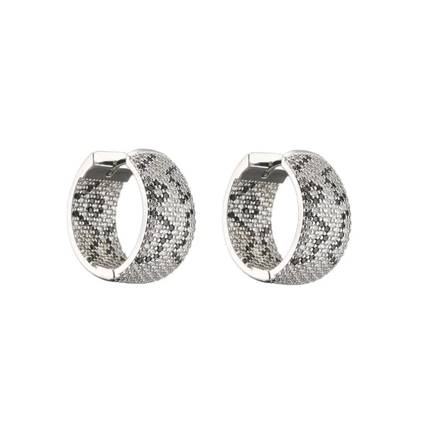 Gold and silver textured hoop earrings, ideal for jewelry cleaning, jewelry storage, jewelry websites, and showcasing luxurious designs by top jewelry designers.