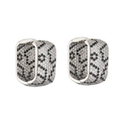 Gold and silver textured hoop earrings, ideal for jewelry cleaning, jewelry storage, jewelry websites, and showcasing luxurious designs by top jewelry designers.