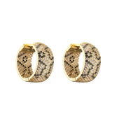 Gold and silver textured hoop earrings, ideal for jewelry cleaning, jewelry storage, jewelry websites, and showcasing luxurious designs by top jewelry designers.