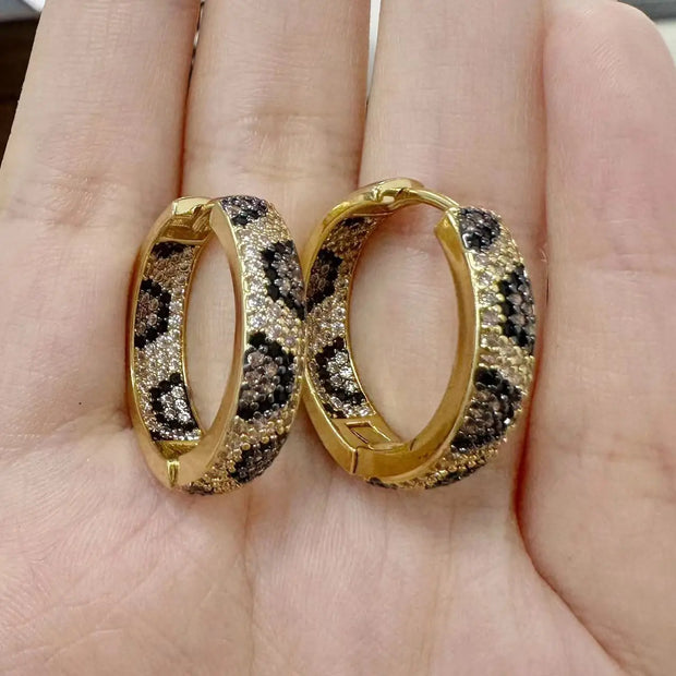 Gold and silver textured hoop earrings, ideal for jewelry cleaning, jewelry storage, jewelry websites, and showcasing luxurious designs by top jewelry designers.