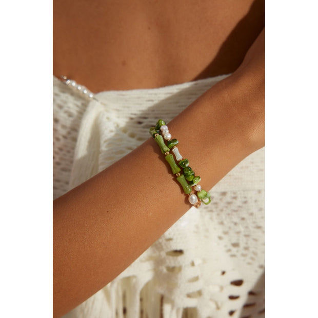 Elegant green bamboo and pearl bracelet with gold accents on a jewelry case, ideal for jewelry storage. Discover unique jewelry designs and jewelry websites for custom pieces like permanent jewelry, gem jewelry, and turquoise jewelry. Perfect for mature women with sophisticated tastes, this vintage jewelry also makes a great gift for mom. Explore jewelry repair close to you, jewelry with engraving, and earrings piercing options. Jewelry brands like Jewelry Unlimited offer beautiful, customizable jewelry suc