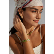 Elegant green bamboo and pearl bracelet with gold accents on a jewelry case, ideal for jewelry storage. Discover unique jewelry designs and jewelry websites for custom pieces like permanent jewelry, gem jewelry, and turquoise jewelry. Perfect for mature women with sophisticated tastes, this vintage jewelry also makes a great gift for mom. Explore jewelry repair close to you, jewelry with engraving, and earrings piercing options. Jewelry brands like Jewelry Unlimited offer beautiful, customizable jewelry suc