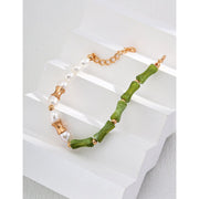 Elegant green bamboo and pearl bracelet with gold accents on a jewelry case, ideal for jewelry storage. Discover unique jewelry designs and jewelry websites for custom pieces like permanent jewelry, gem jewelry, and turquoise jewelry. Perfect for mature women with sophisticated tastes, this vintage jewelry also makes a great gift for mom. Explore jewelry repair close to you, jewelry with engraving, and earrings piercing options. Jewelry brands like Jewelry Unlimited offer beautiful, customizable jewelry suc