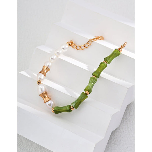Elegant green bamboo and pearl bracelet with gold accents on a jewelry case, ideal for jewelry storage. Discover unique jewelry designs and jewelry websites for custom pieces like permanent jewelry, gem jewelry, and turquoise jewelry. Perfect for mature women with sophisticated tastes, this vintage jewelry also makes a great gift for mom. Explore jewelry repair close to you, jewelry with engraving, and earrings piercing options. Jewelry brands like Jewelry Unlimited offer beautiful, customizable jewelry suc