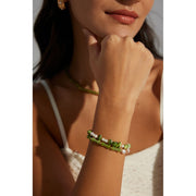 Elegant green bamboo and pearl bracelet with gold accents on a jewelry case, ideal for jewelry storage. Discover unique jewelry designs and jewelry websites for custom pieces like permanent jewelry, gem jewelry, and turquoise jewelry. Perfect for mature women with sophisticated tastes, this vintage jewelry also makes a great gift for mom. Explore jewelry repair close to you, jewelry with engraving, and earrings piercing options. Jewelry brands like Jewelry Unlimited offer beautiful, customizable jewelry suc