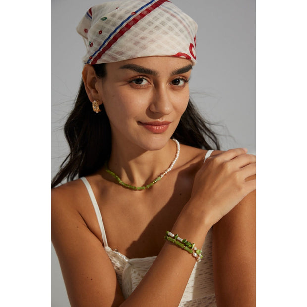 Elegant green bamboo and pearl bracelet with gold accents on a jewelry case, ideal for jewelry storage. Discover unique jewelry designs and jewelry websites for custom pieces like permanent jewelry, gem jewelry, and turquoise jewelry. Perfect for mature women with sophisticated tastes, this vintage jewelry also makes a great gift for mom. Explore jewelry repair close to you, jewelry with engraving, and earrings piercing options. Jewelry brands like Jewelry Unlimited offer beautiful, customizable jewelry suc