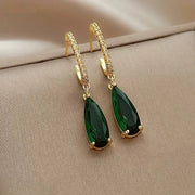 Elegant gold teardrop earrings with vibrant green gemstones and diamond accents, showcasing stunning craftsmanship by jewelry designers, ideal for vintage jewelry lovers.