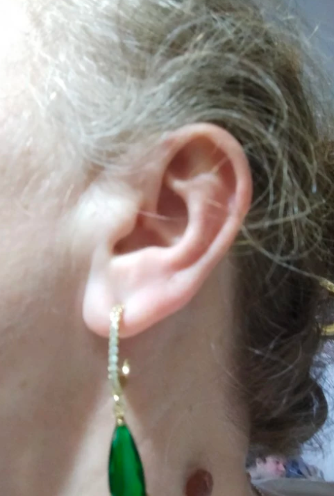 Elegant gold teardrop earrings with vibrant green gemstones and diamond accents, showcasing stunning craftsmanship by jewelry designers, ideal for vintage jewelry lovers.