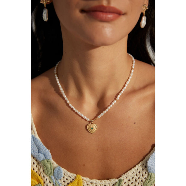 Gold and silver heart pendant pearl necklaces with gemstones, perfect for jewelry storage, vintage jewelry collections, or gifts for mom. Featured on jewelry websites with designs inspired by leading jewelry designers. Great for pairing with earrings piercing styles, diamond and jewelry sets, or turquoise jewelry. Ideal for mature women hairstyles and fashion.
