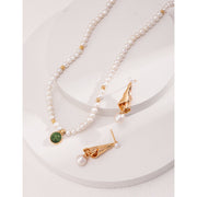 Elegant pearl necklace with gold accents and green gemstone pendant, perfect for vintage jewelry collections, jewelry storage, jewelry for mom, and jewelry cleaning.