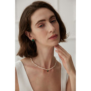 Elegant pearl necklace with gold accents and green gemstone pendant, perfect for vintage jewelry collections, jewelry storage, jewelry for mom, and jewelry cleaning.