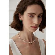 Elegant pearl necklace with gold accents and green gemstone pendant, perfect for vintage jewelry collections, jewelry storage, jewelry for mom, and jewelry cleaning.