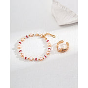 Elegant pink pearl and ruby gemstone bracelet with gold accents, perfect for jewelry websites, vintage jewelry lovers, and gift ideas like jewelry for mom.