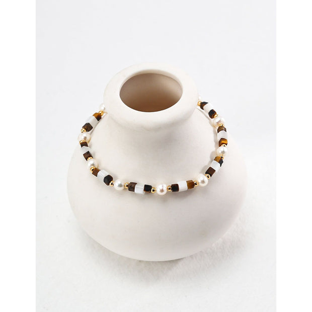 Elegant pearl and bead bracelet with gold accents, ideal for jewelry storage, jewelry designers, and jewelry websites. Perfect for vintage jewelry collections or jewelry for mom.