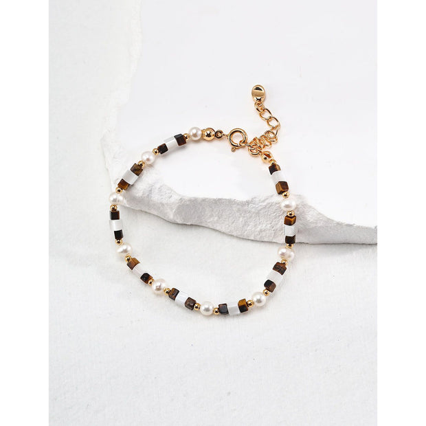 Elegant pearl and bead bracelet with gold accents, ideal for jewelry storage, jewelry designers, and jewelry websites. Perfect for vintage jewelry collections or jewelry for mom.