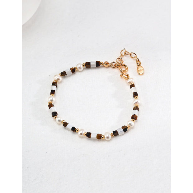 Elegant pearl and bead bracelet with gold accents, ideal for jewelry storage, jewelry designers, and jewelry websites. Perfect for vintage jewelry collections or jewelry for mom.