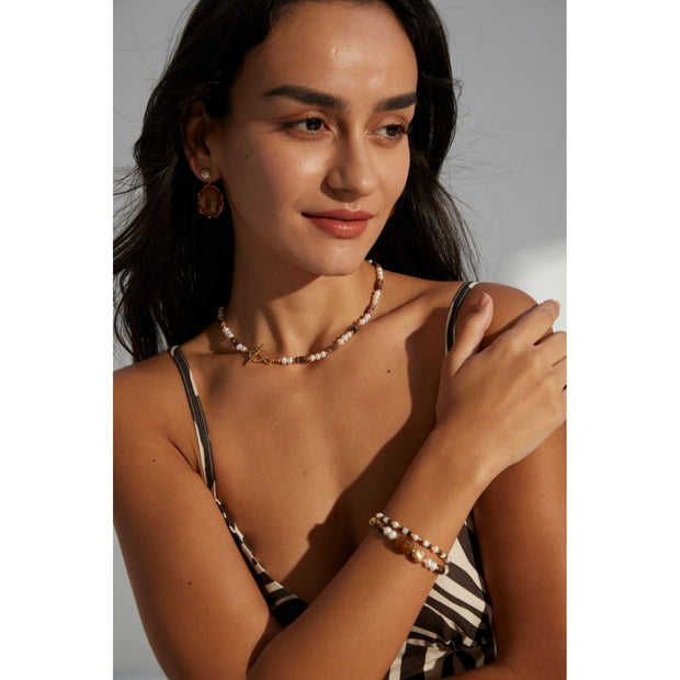 Elegant pearl and bead bracelet with gold accents, ideal for jewelry storage, jewelry designers, and jewelry websites. Perfect for vintage jewelry collections or jewelry for mom.