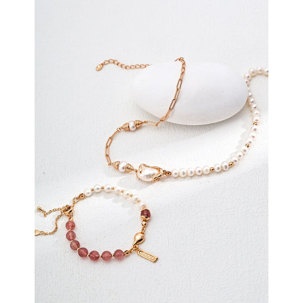 Elegant pink bead and pearl bracelet with a gold chain and engraved charm, ideal for jewelry storage in a jewelry case. Perfect for jewelry designers, gem jewelry, or jewelry websites. A timeless piece for vintage jewelry lovers, jewelry brands, or permanent jewelry seekers.