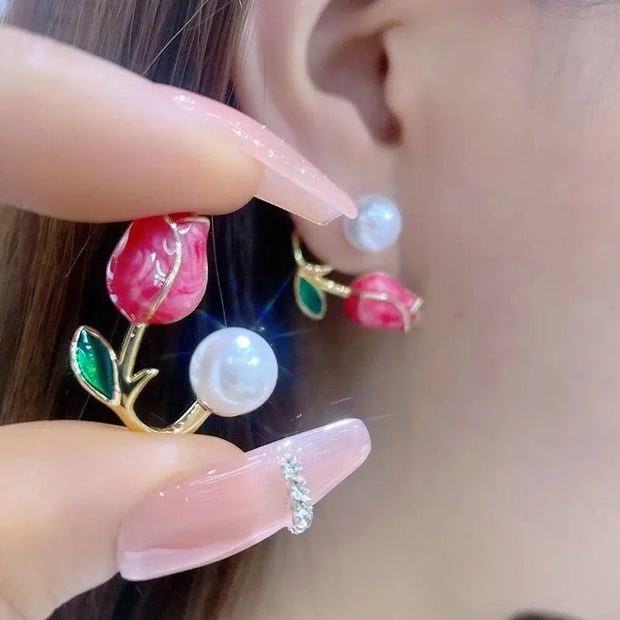 Flower and pearl stud earrings with pink petals, green leaves, and gold accents, perfect for jewelry websites, jewelry storage, vintage jewelry, and gifting for mom.