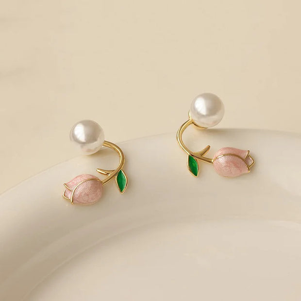 Flower and pearl stud earrings with pink petals, green leaves, and gold accents, perfect for jewelry websites, jewelry storage, vintage jewelry, and gifting for mom.