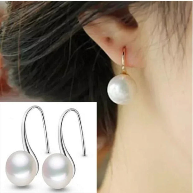 Elegant silver drop earrings with luminous freshwater pearls, ideal for earrings piercing, jewelry storage, vintage jewelry collections, and gifting. Perfect for jewelry websites or body jewelry enthusiasts.