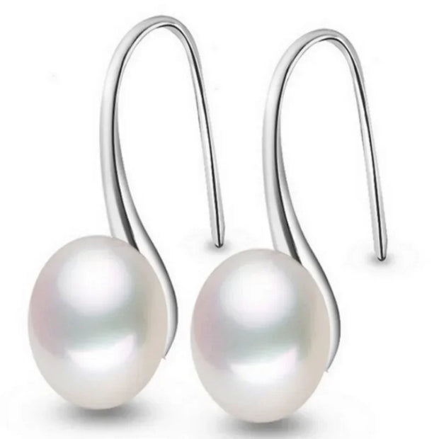 Elegant silver drop earrings with luminous freshwater pearls, ideal for earrings piercing, jewelry storage, vintage jewelry collections, and gifting. Perfect for jewelry websites or body jewelry enthusiasts.
