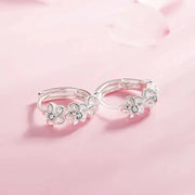 Elegant silver floral hoop earrings with crystals, perfect for earrings piercing and earrings rings collections. Ideal for jewelry storage, jewelry websites, and vintage jewelry lovers.