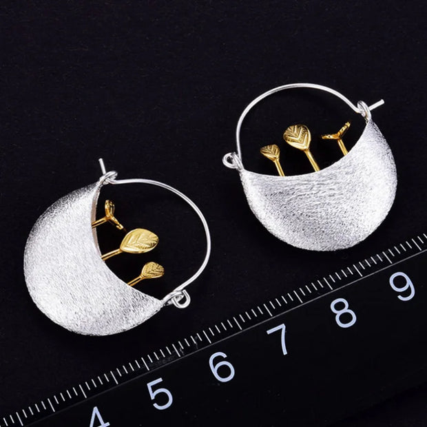 Elegant silver and gold leaf earrings showcasing unique jewelry designers' artistry, perfect for vintage jewelry websites, jewelry storage, and gift for mom.