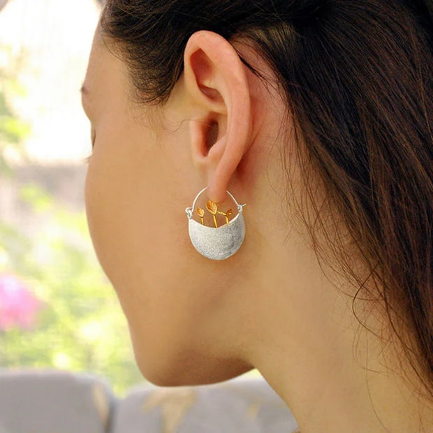 Elegant silver and gold leaf earrings showcasing unique jewelry designers' artistry, perfect for vintage jewelry websites, jewelry storage, and gift for mom.