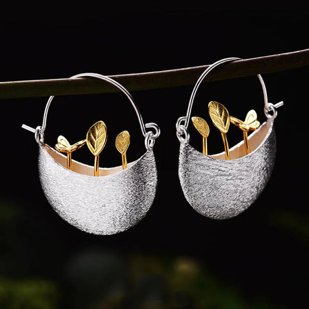 Elegant silver and gold leaf earrings showcasing unique jewelry designers' artistry, perfect for vintage jewelry websites, jewelry storage, and gift for mom.