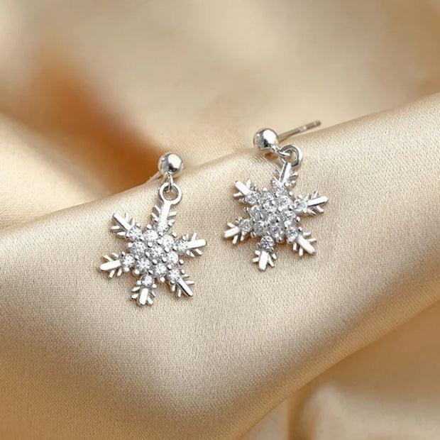 Festive snowflake earrings with red bows in a velvet jewelry case, perfect for holiday jewelry storage, designed by expert jewelry designers for elegant occasions. Ideal for earrings piercing lovers, mature women hairstyles, and those seeking jewelry websites or jewelry for mom. Suitable for vintage jewelry collections, body jewelry enthusiasts, or jewelry brands focusing on gem jewelry and diamond and jewelry.