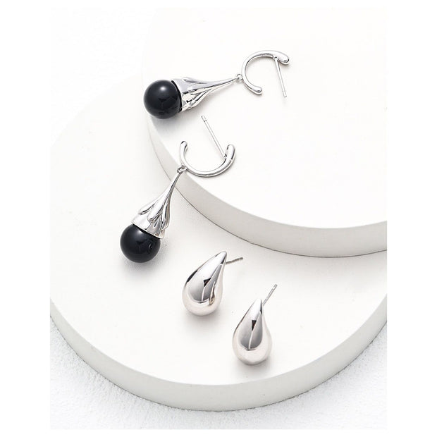 Teardrop stud earrings in rose gold and silver, perfect for jewelry storage, earrings piercing, and jewelry websites. Elegant design for body jewelry lovers and jewelry designers.