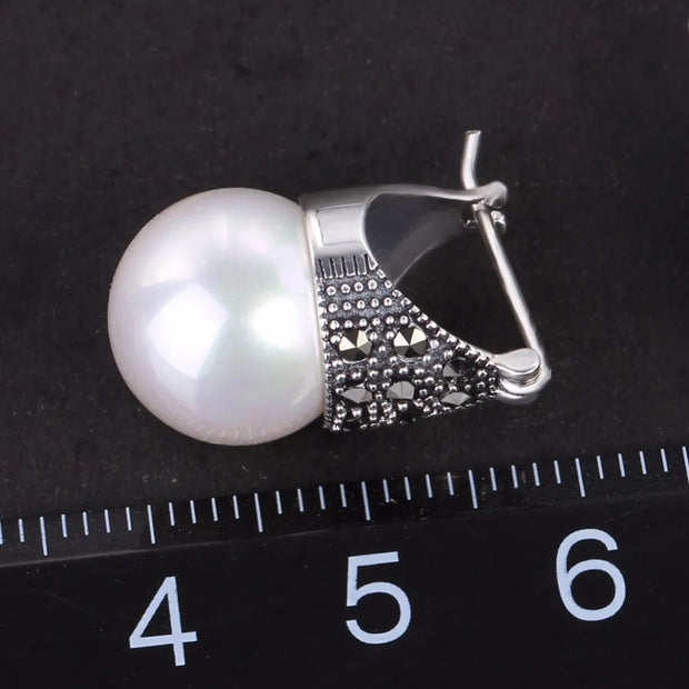 Elegant vintage pearl drop earrings with marcasite detailing, perfect for jewelry storage, jewelry websites, jewelry cleaning, and timeless vintage jewelry collections.