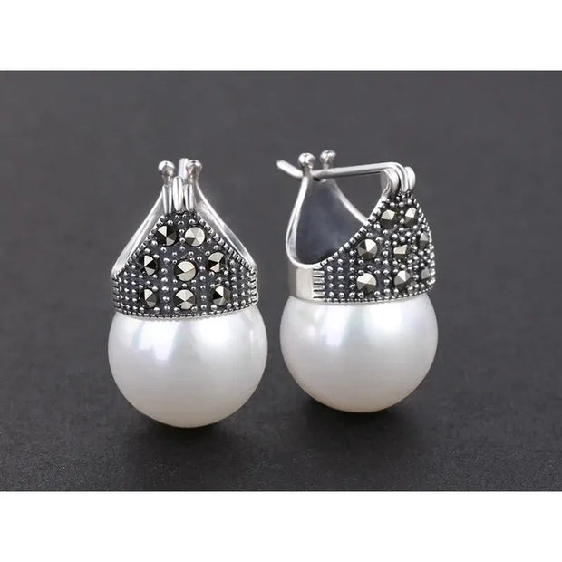 Elegant vintage pearl drop earrings with marcasite detailing, perfect for jewelry storage, jewelry websites, jewelry cleaning, and timeless vintage jewelry collections.