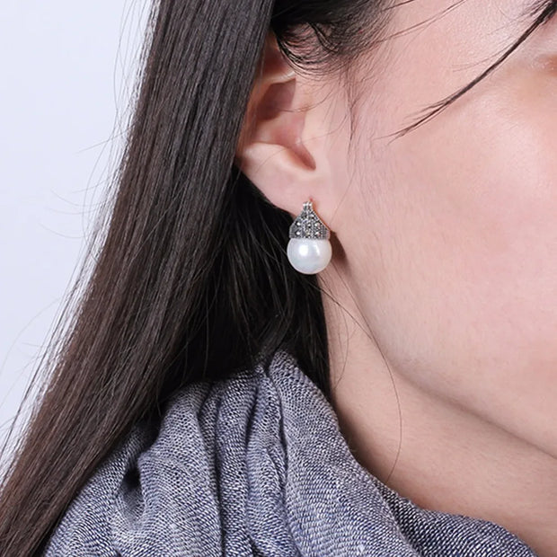 Elegant vintage pearl drop earrings with marcasite detailing, perfect for jewelry storage, jewelry websites, jewelry cleaning, and timeless vintage jewelry collections.