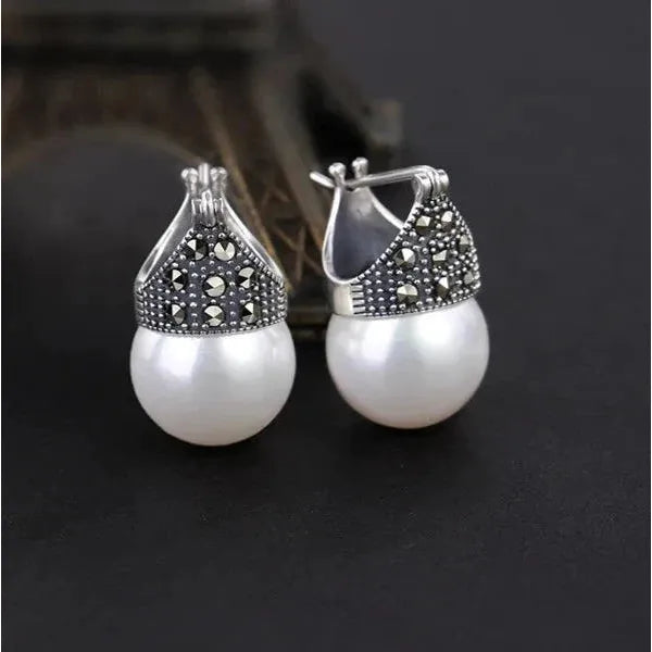 Elegant vintage pearl drop earrings with marcasite detailing, perfect for jewelry storage, jewelry websites, jewelry cleaning, and timeless vintage jewelry collections.