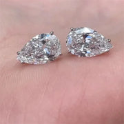 Pear-cut diamond earrings with sparkling stones, crafted by expert jewelry designers, ideal for display on jewelry websites or storage in a jewelry case.