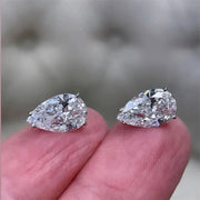 Pear-cut diamond earrings with sparkling stones, crafted by expert jewelry designers, ideal for display on jewelry websites or storage in a jewelry case.