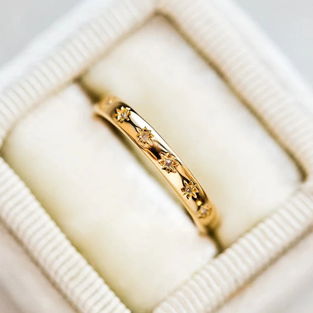 Gold band ring with star-shaped diamond engravings, perfect for jewelry designers, vintage jewelry collections, or jewelry websites specializing in elegant body jewelry.