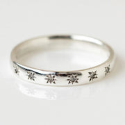 Gold band ring with star-shaped diamond engravings, perfect for jewelry designers, vintage jewelry collections, or jewelry websites specializing in elegant body jewelry.