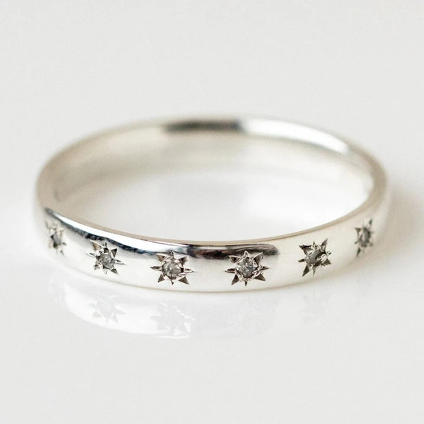 Gold band ring with star-shaped diamond engravings, perfect for jewelry designers, vintage jewelry collections, or jewelry websites specializing in elegant body jewelry.