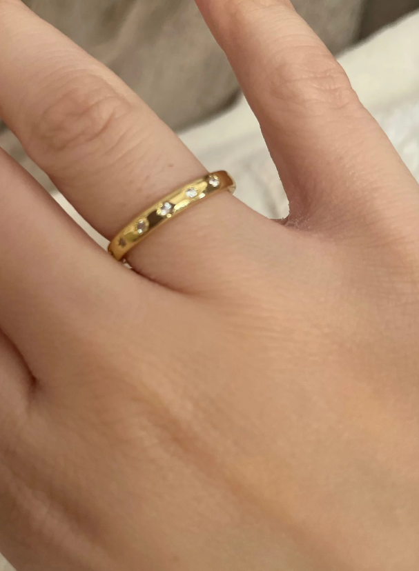 Gold band ring with star-shaped diamond engravings, perfect for jewelry designers, vintage jewelry collections, or jewelry websites specializing in elegant body jewelry.
