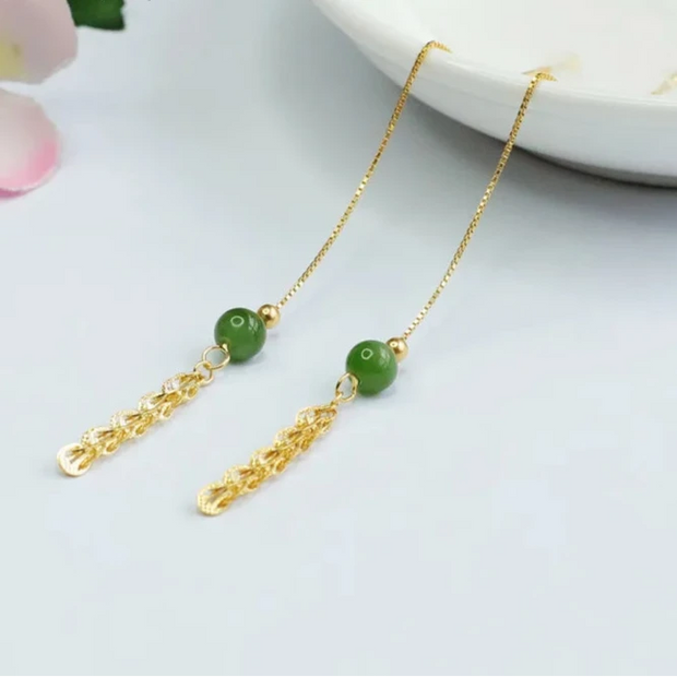 Elegant gold chain threader earrings with green beads for earrings piercing, perfect for jewelry storage, vintage jewelry enthusiasts, or turquoise jewelry lovers. Ideal for jewelry cleaning tips, jewelry websites, and showcasing jewelry for mom. Suitable for pairing with gem jewelry, body jewelry, or emerald ring jewelry. Great addition to jewelry cases and inspired by modern jewelry designers.