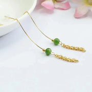 Elegant gold chain threader earrings with green beads for earrings piercing, perfect for jewelry storage, vintage jewelry enthusiasts, or turquoise jewelry lovers. Ideal for jewelry cleaning tips, jewelry websites, and showcasing jewelry for mom. Suitable for pairing with gem jewelry, body jewelry, or emerald ring jewelry. Great addition to jewelry cases and inspired by modern jewelry designers.
